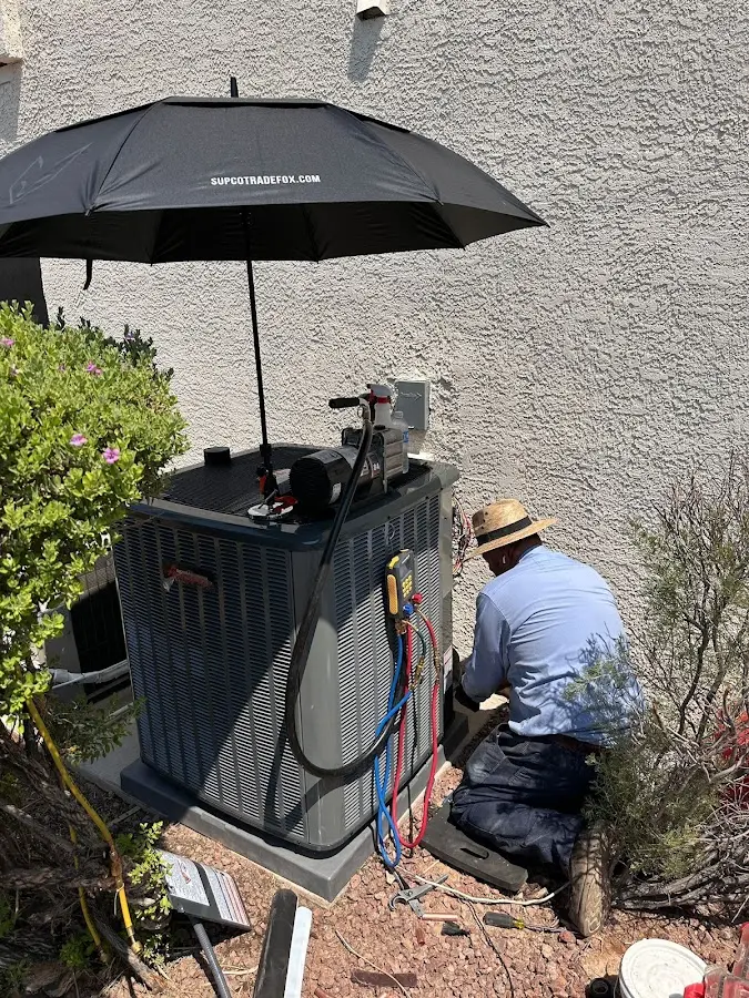 HVAC technician performing outdoor AC maintenance in Shrewsbury