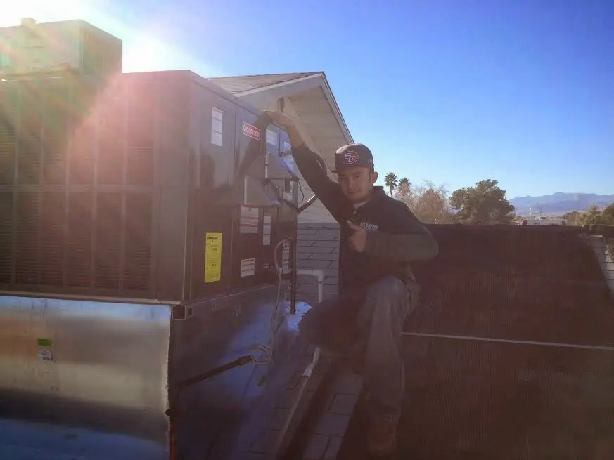HVAC technician performing HVAC Inspection on a rooftop unit in Shrewsbury